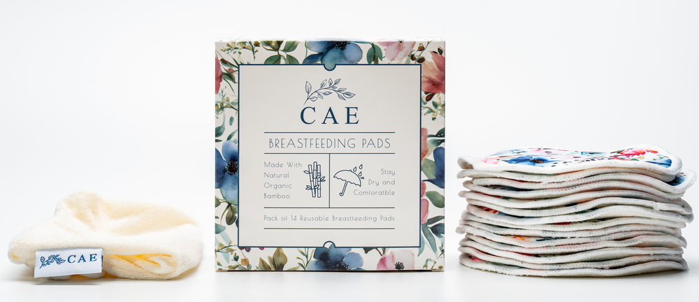 Open CAE box showing washable bamboo breast pads stacked beside it